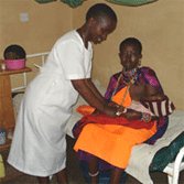 Kenyan nurse attends mother and child Kenyan nurse attends mother and child